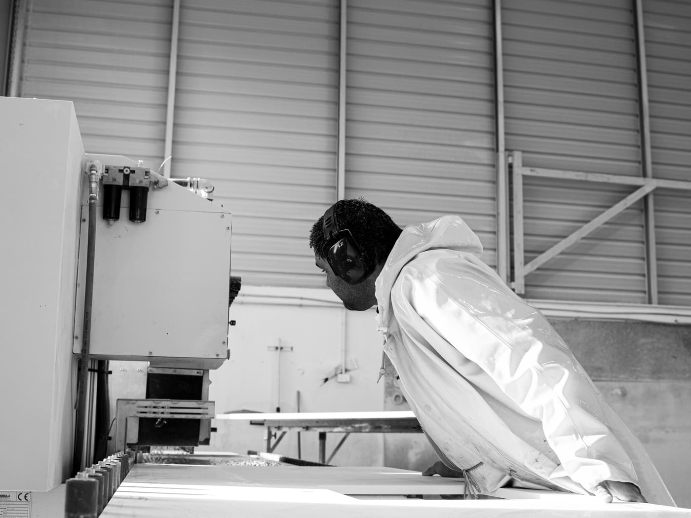 Fabricator checking a benchtop on the machine bed